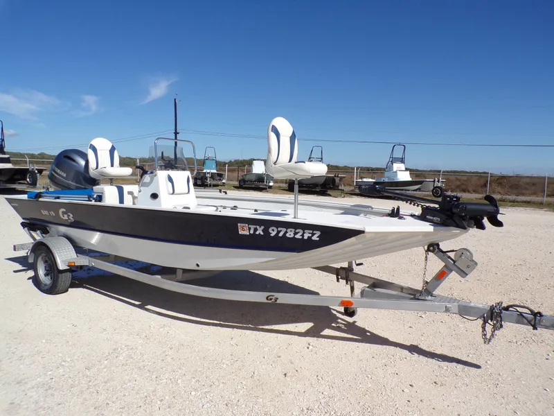 Slide: The Image of A 2018 G3 Bay 18 boat on a trailer, featuring two seats and an outboard motor. - 11