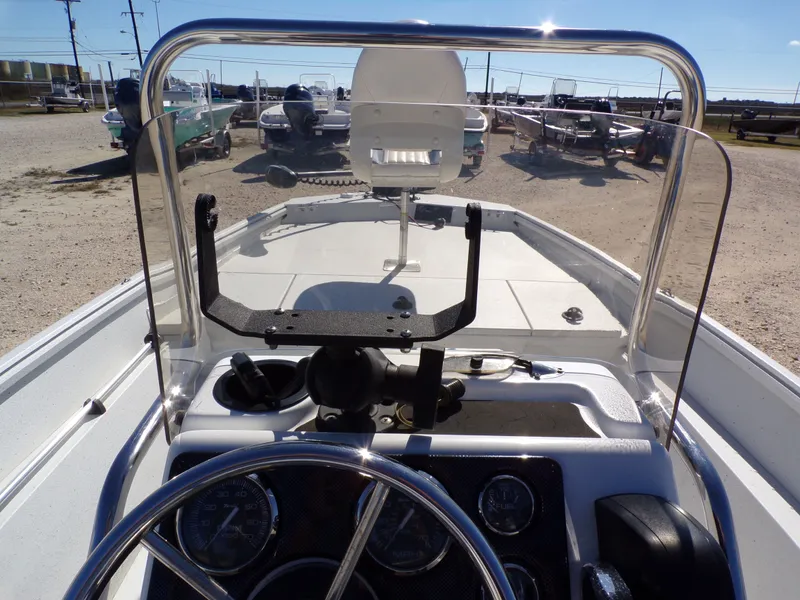 Slide: The Image of The image shows the cockpit of a 2018 G3 Bay 18 boat with steering and instruments. - 24