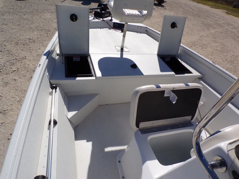 Slide: The Image of The image shows the deck of a 2018 G3 Bay 18 boat with storage and seating. - 17