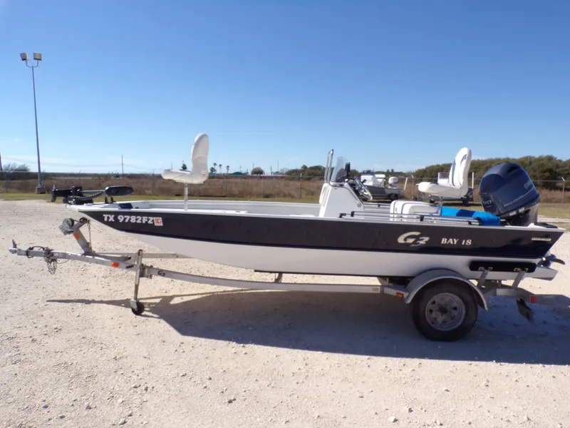Slide: The Image of A 2018 G3 Bay 18 boat on a trailer in a gravel lot. - 8