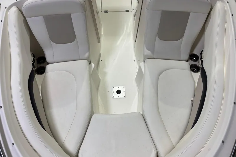 Slide: The Image of Interior seating of 2008 Chaparral 236 SSX boat, featuring white cushioned seats. - 15