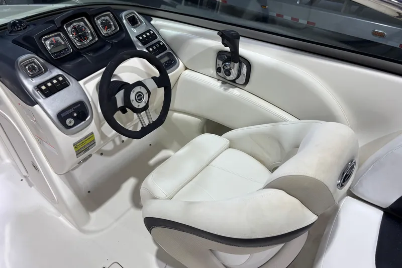 Slide: The Image of 2008 Chaparral 236 SSX boat cockpit with steering wheel and control panel. - 10