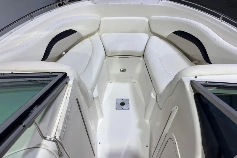 Slide: The Image of 2008 Chaparral 236 SSX boat interior with white cushioned seating and sleek design. - 13