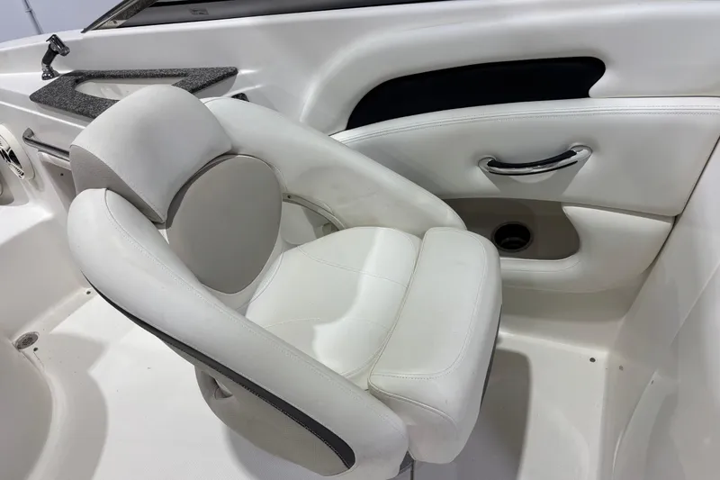 Slide: The Image of White leather seat in 2008 Chaparral 236 SSX boat interior. - 9
