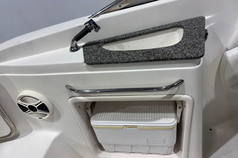 Slide: The Image of 2008 Chaparral 236 SSX boat interior with sink, speaker, and cooler storage. - 8