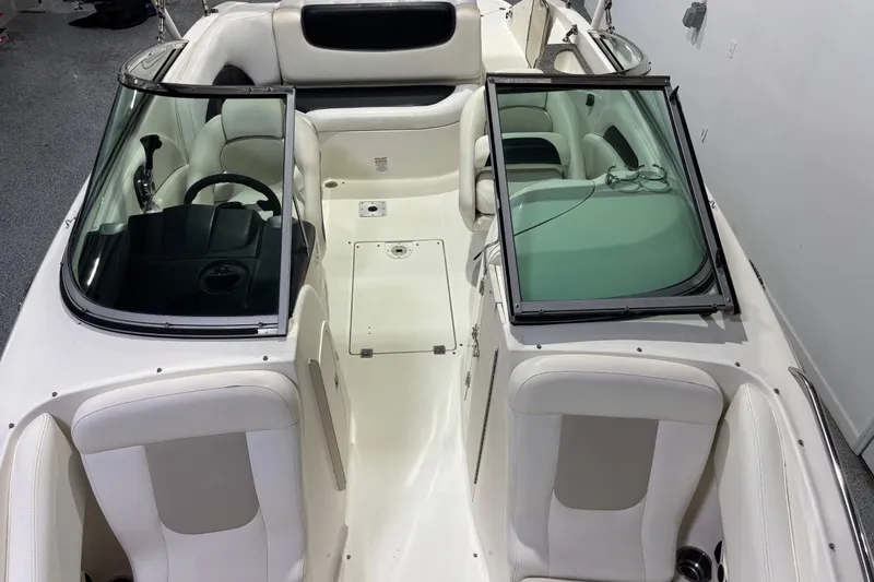 Slide: The Image of 2008 Chaparral 236 SSX boat interior with white seating and open windshield. - 14