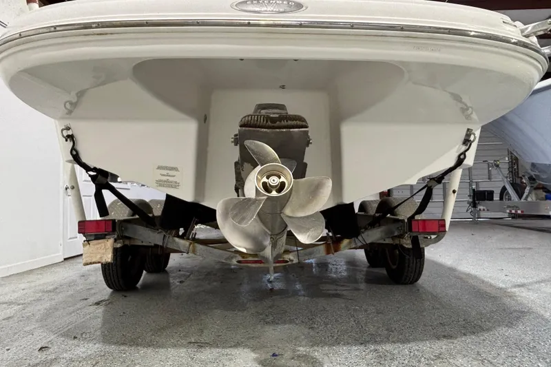 Slide: The Image of Rear view of a 2008 Chaparral 236 SSX boat on a trailer in a garage. - 3