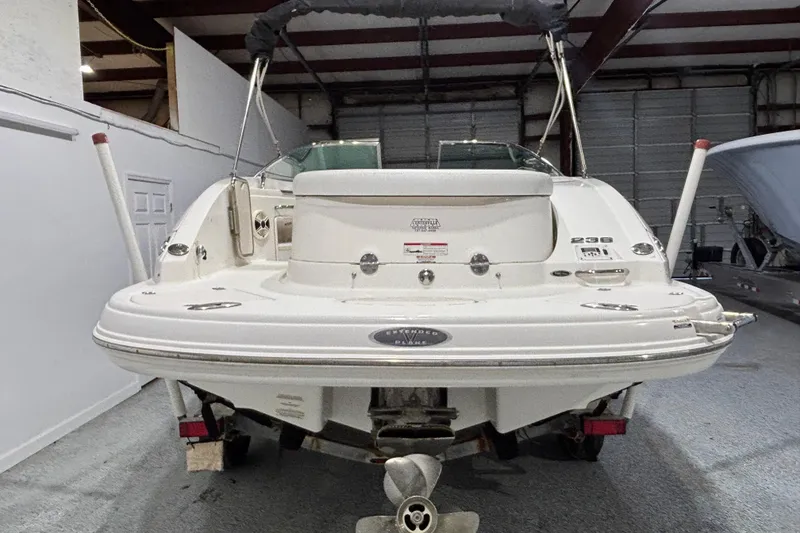 Slide: The Image of 2008 Chaparral 236 SSX boat in indoor storage, rear view. - 2