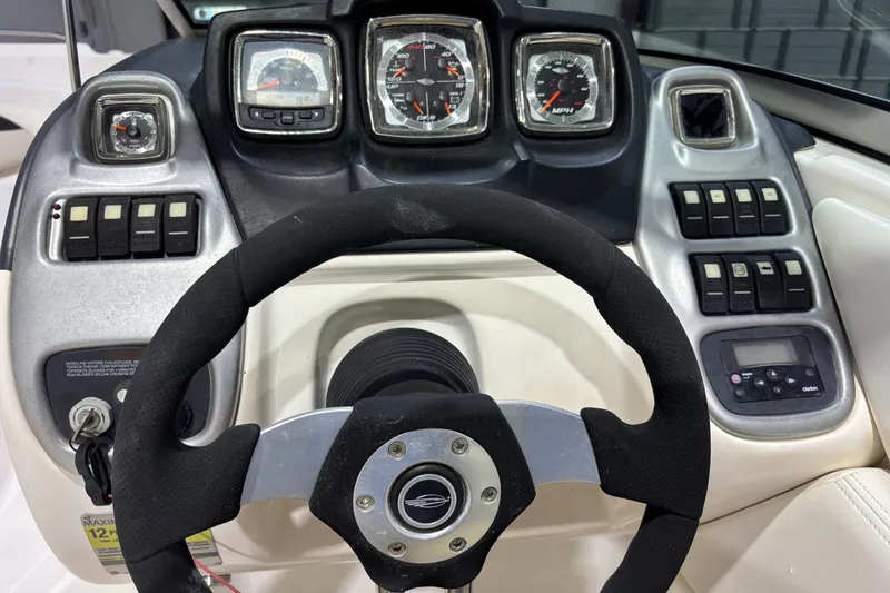 Slide: The Image of Dashboard of a 2008 Chaparral 236 SSX boat with steering wheel and gauges. - 11
