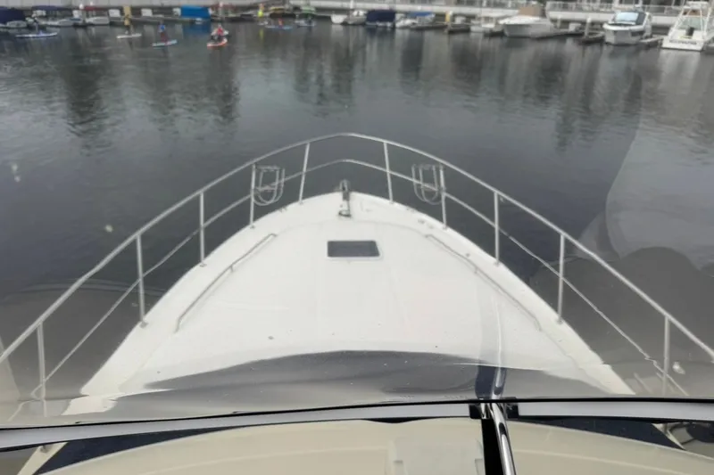 Slide: The Image of Bow view of 1997 Sea Ray 420 Aft Cabin yacht in marina. - 1