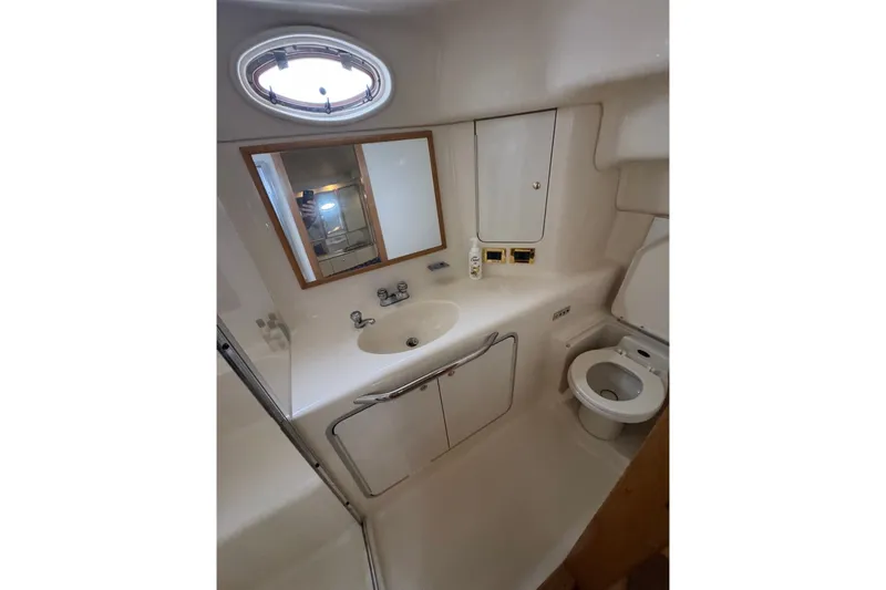 Slide: The Image of Bathroom interior of 1997 Sea Ray 420 Aft Cabin yacht, featuring sink and toilet. - 17