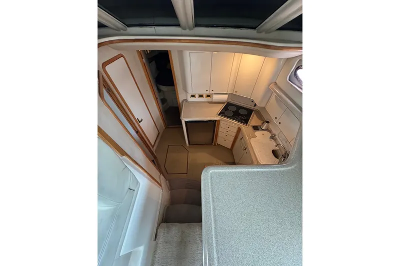 Slide: The Image of Interior view of 1997 Sea Ray 420 Aft Cabin kitchen with modern amenities. - 8
