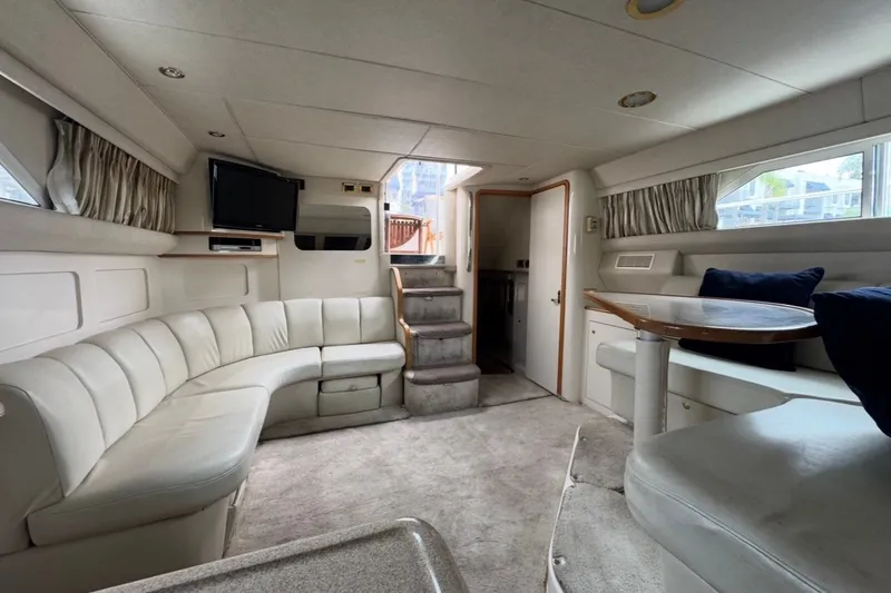 Slide: The Image of Luxurious interior of a 1997 Sea Ray 420 Aft Cabin yacht with plush seating and elegant decor. - 7