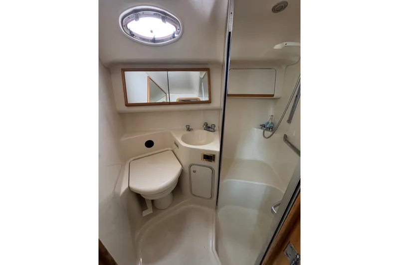 Slide: The Image of 1997 Sea Ray 420 Aft Cabin bathroom with shower, sink, and toilet. - 16