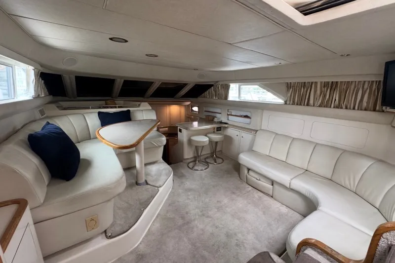 Slide: The Image of Luxurious interior of a 1997 Sea Ray 420 Aft Cabin yacht with plush seating and elegant design. - 5