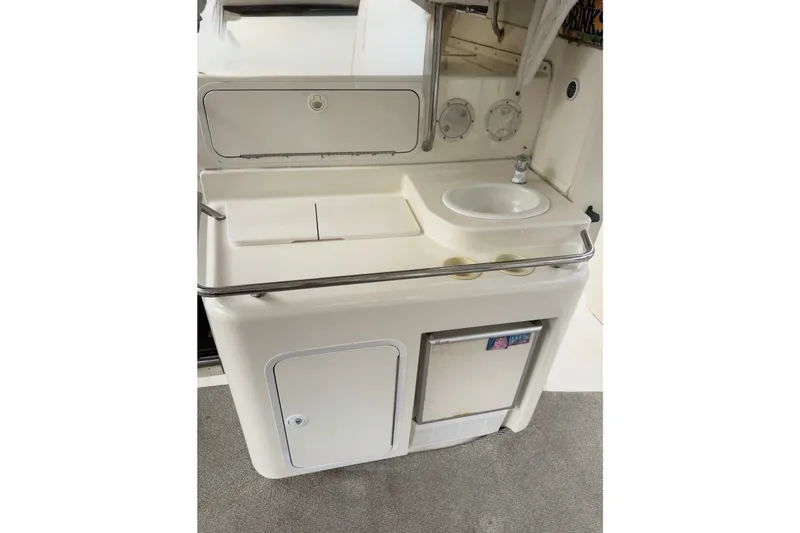 Slide: The Image of 1997 Sea Ray 420 Aft Cabin yacht kitchenette with sink and mini fridge. - 14
