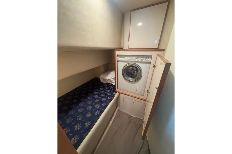 Slide: The Image of Laundry area with washer and storage in 1997 Sea Ray 420 Aft Cabin yacht. - 13