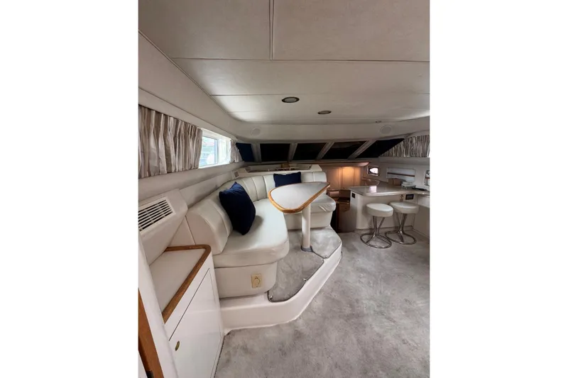Slide: The Image of Interior of 1997 Sea Ray 420 Aft Cabin yacht with plush seating and modern amenities. - 6