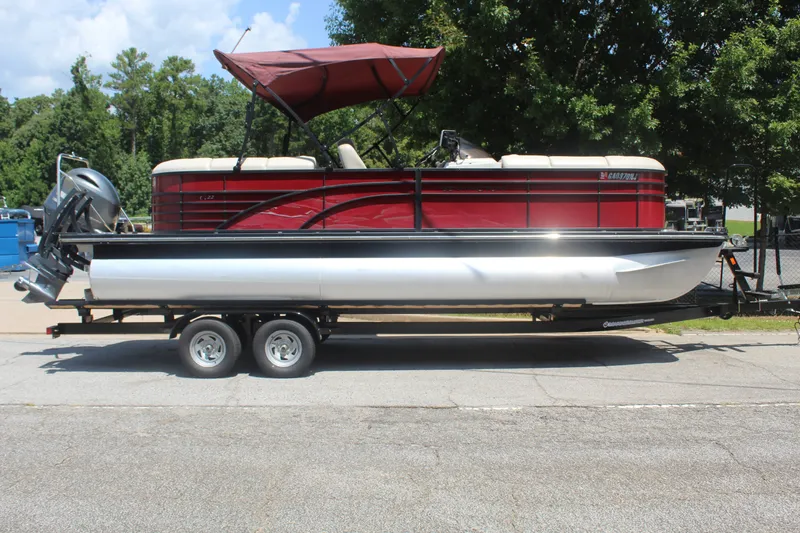 Slide: The Image of A red 2016 Bennington 2250GSR pontoon boat on a trailer, featuring a canopy and outboard motor. - 6