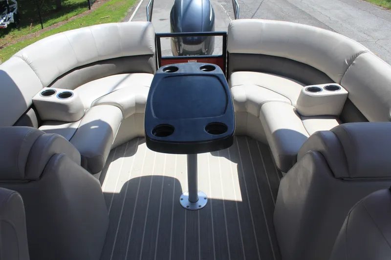 Slide: The Image of The image shows the cockpit of a 2016 Bennington 2250GSR with beige seating and a table. - 12
