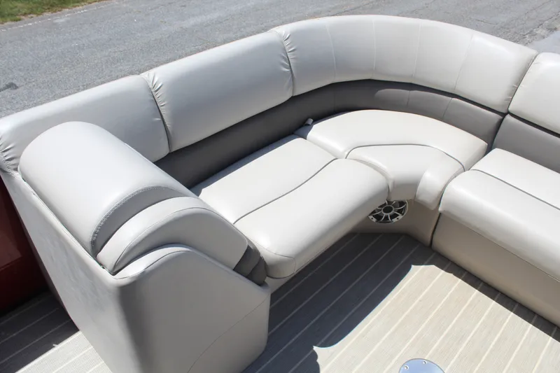 Slide: The Image of The 2016 Bennington 2250GSR features luxurious cream-colored upholstery in an L-shaped seating arrangement. - 14