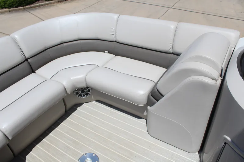Slide: The Image of The image shows the seating area of a 2016 Bennington 2250GSR pontoon boat with gray upholstery. - 15