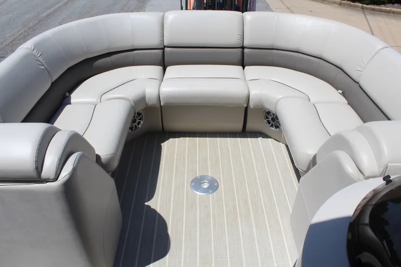 Slide: The Image of The image shows the spacious, cushioned seating area of a 2016 Bennington 2250GSR pontoon boat. - 13