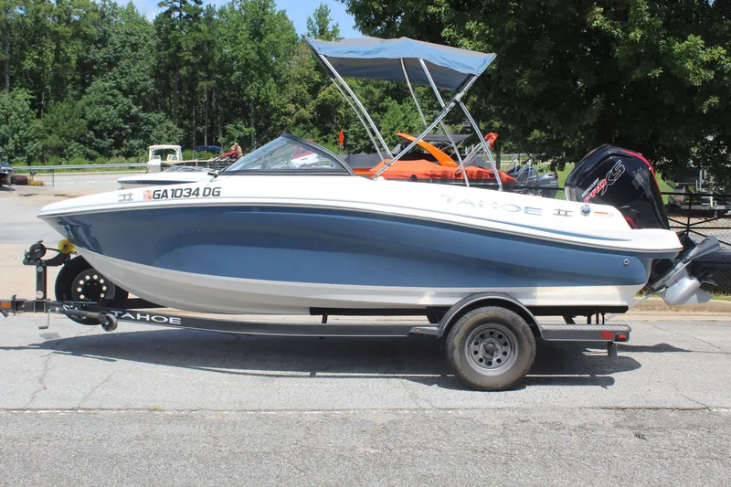 The Image of A 2022 Tracker Tahoe 185S boat on a trailer, featuring a blue hull and a sunshade. - 1