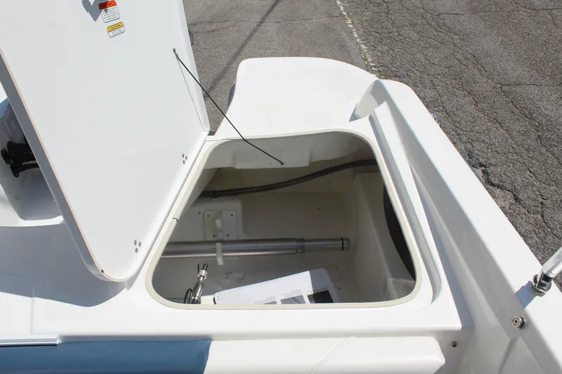 Slide: The Image of An open storage compartment on a boat with visible lid and interior. - 14