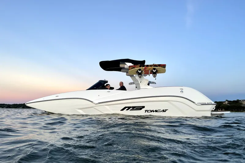 The Image of 2021 MB F24 Tomcat Alpha boat cruising on calm waters at sunset. - 0