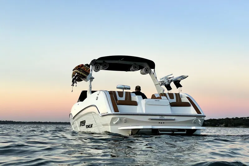 Slide: The Image of 2021 MB F24 Tomcat Alpha boat on water at sunset, rear view. - 3