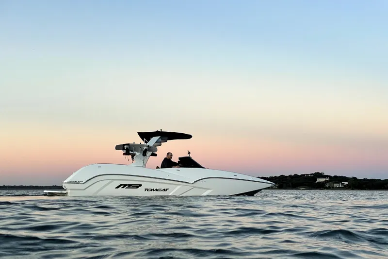 Slide: The Image of 2021 MB F24 Tomcat Alpha boat on calm water at sunset. - 4