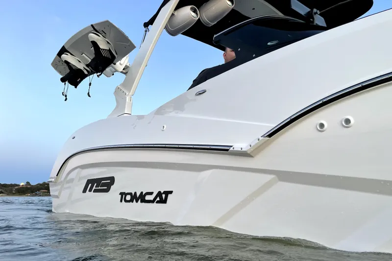 Slide: The Image of 2021 MB F24 Tomcat Alpha boat on water, showcasing sleek design and branding. - 2