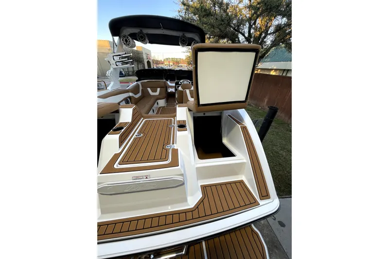 Slide: The Image of 2021 MB F24 Tomcat Alpha boat interior with brown and white seating and deck. - 11