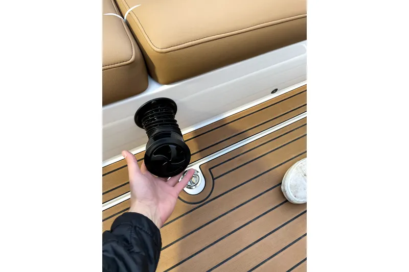 Slide: The Image of Hand holding a black component on MB F24 Tomcat Alpha boat deck, 2021 model. - 15