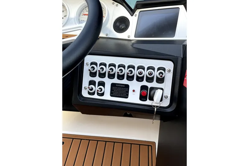 Slide: The Image of Control panel of 2021 MB F24 Tomcat Alpha boat with switches and key ignition. - 16