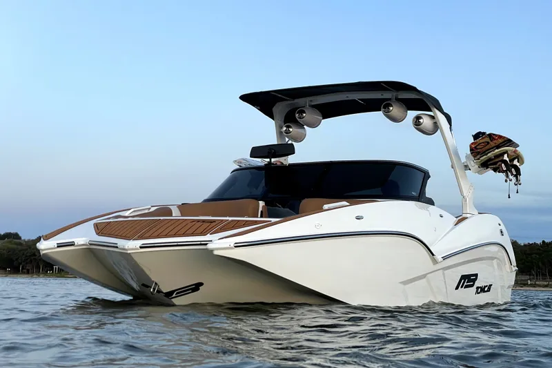 Slide: The Image of 2021 MB F24 Tomcat Alpha boat on water, showcasing sleek design and modern features. - 1