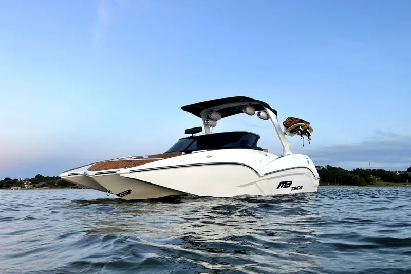 Slide: The Image of 2021 MB F24 Tomcat Alpha boat on calm water at sunset. - 6