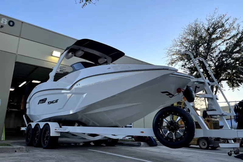 Slide: The Image of 2021 MB F24 Tomcat Alpha boat on trailer outside a warehouse. - 18