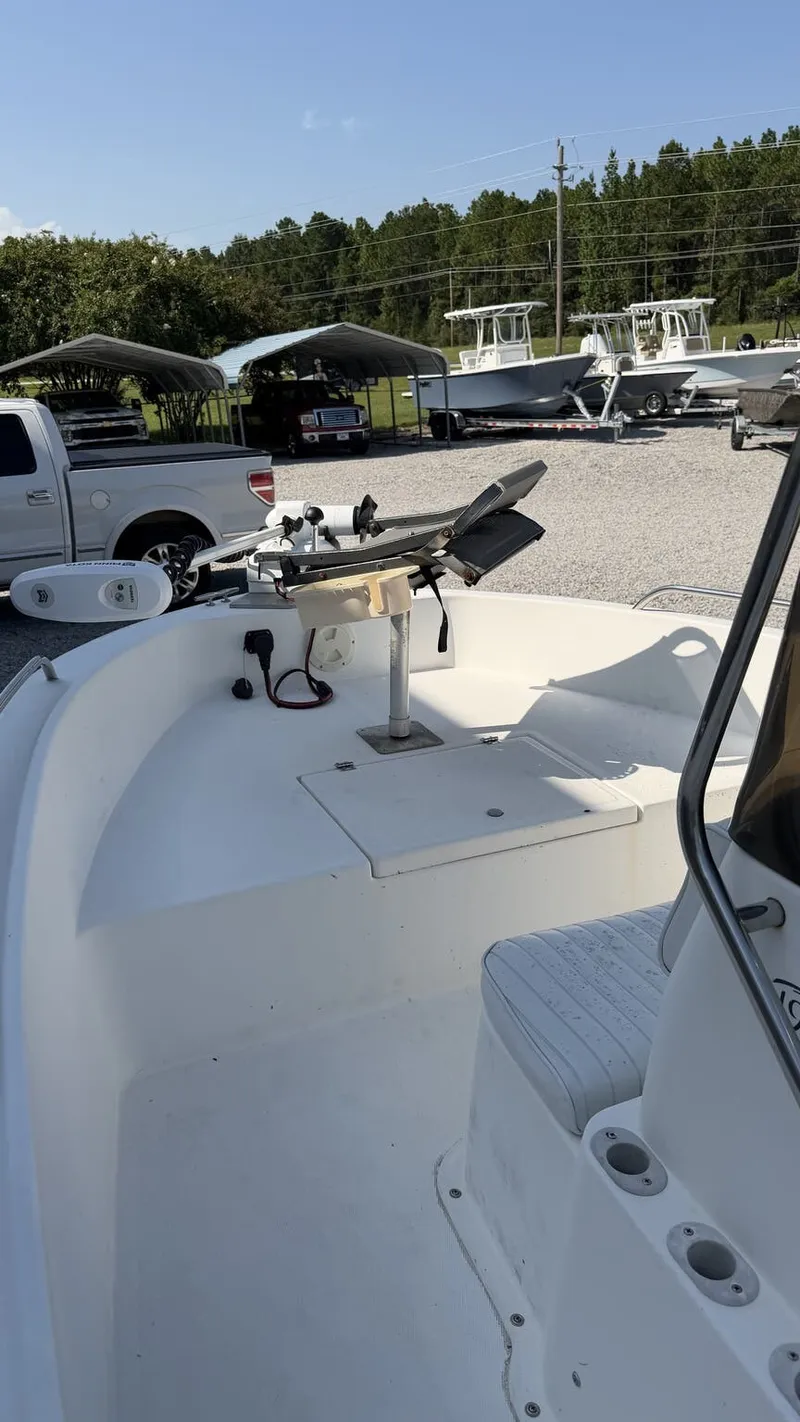 Slide: The Image of A 2010 Clearwater 1900 Center Console boat with a clean, white deck and steering console. - 8