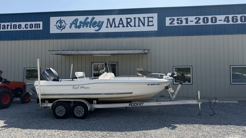 The Image of A 2010 Clearwater 1900 Center Console boat on a trailer in front of a building. - 1