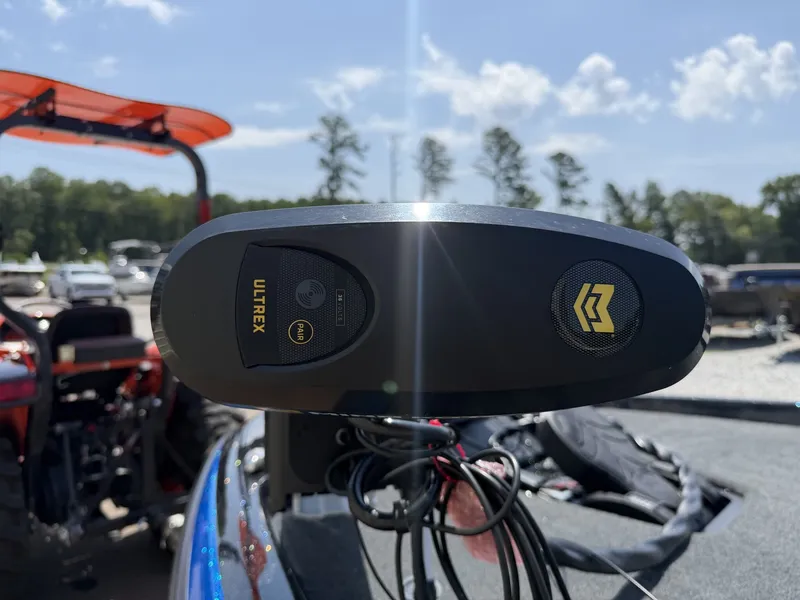 Slide: The Image of Close-up of an Ulterra motor on a Skeeter ZXR Series 20SE boat, surrounded by trees. - 4