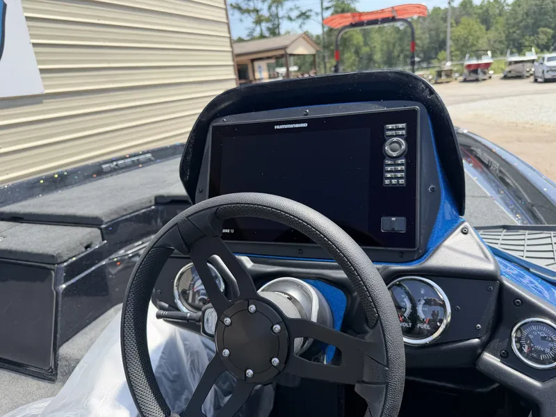Slide: The Image of The image shows the cockpit of a Skeeter ZXR Series 20SE boat with a modern steering wheel and large display. - 7