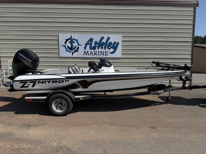 The Image of A white 2015 Nitro Z-7 boat with a 150HP Mercury engine on a trailer. - 1
