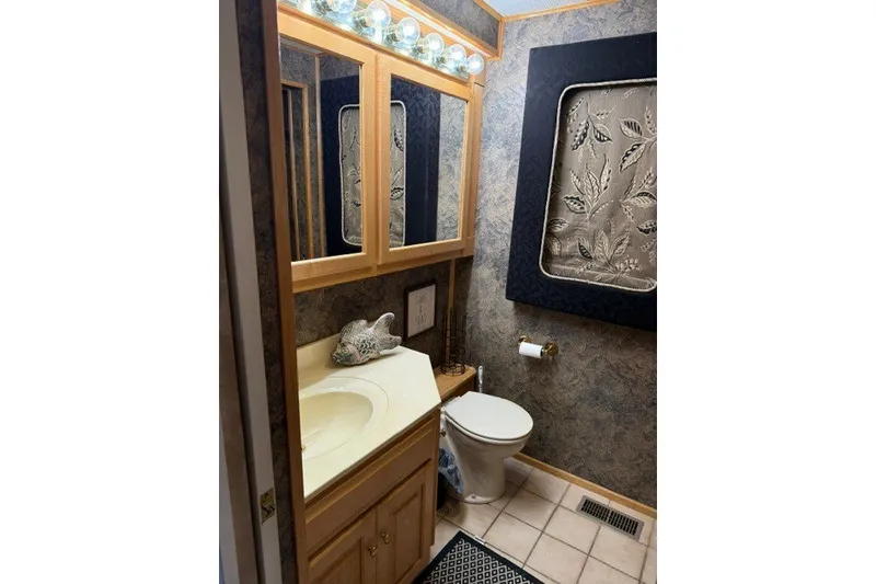Slide: The Image of Bathroom interior of a 1995 Stardust Cruisers 18 x 65 houseboat, featuring elegant decor. - 21