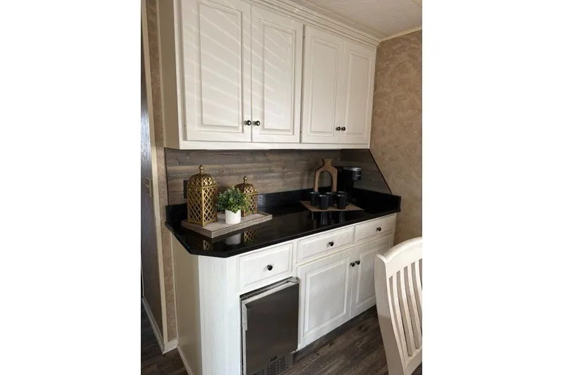 Slide: The Image of Kitchen area in a 1995 Stardust Cruisers 18 x 65 houseboat with white cabinets and black countertop. - 16