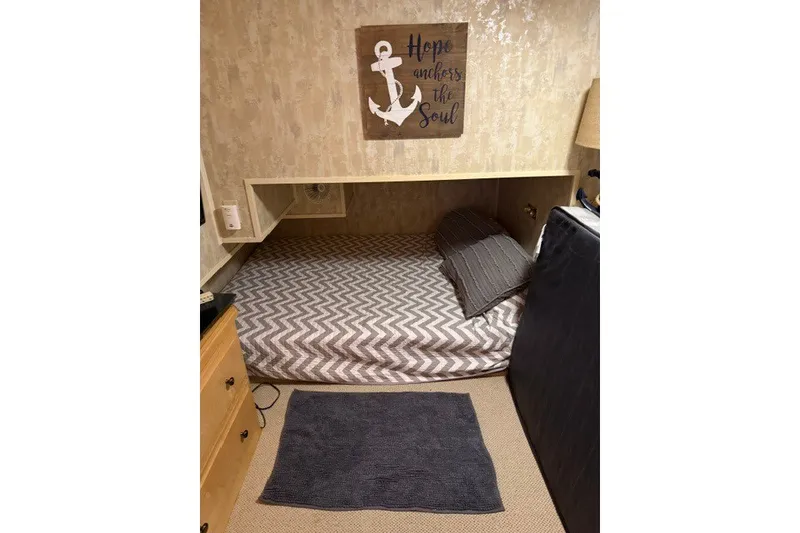 Slide: The Image of Cozy bedroom in 1995 Stardust Cruisers houseboat with nautical decor and chevron bedding. - 28