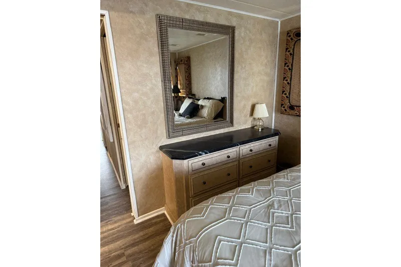 Slide: The Image of Luxurious bedroom interior of 1995 Stardust Cruisers houseboat with elegant dresser and mirror. - 24
