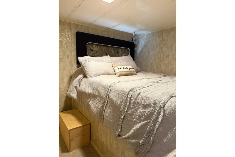 Slide: The Image of Cozy bedroom interior on 1995 Stardust Cruisers 18 x 65 houseboat with plush bedding. - 17