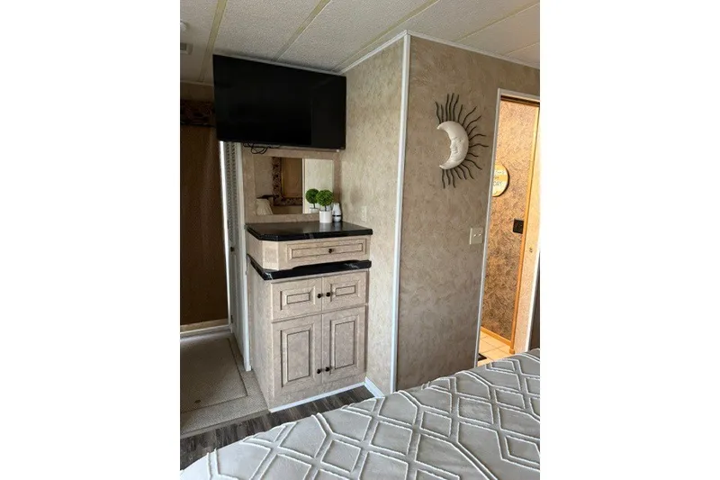Slide: The Image of 1995 Stardust Cruisers houseboat interior with TV, cabinet, and decorative wall art. - 25